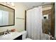 This bathroom features neutral colored tile and a shower with a patterned curtain at 2305 Barnor Dr, Indianapolis, IN 46219