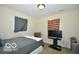This bedroom has neutral walls, a window, and is furnished with a bed, TV, and dresser at 2305 Barnor Dr, Indianapolis, IN 46219
