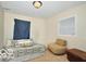 This bedroom is carpeted and furnished with a bed and chair by a window at 2305 Barnor Dr, Indianapolis, IN 46219