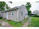 Beige single story house with lawn and chain link fence at 2305 Barnor Dr, Indianapolis, IN 46219