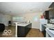 Kitchen showcasing dark cabinetry, granite countertops, and modern appliances at 2305 Barnor Dr, Indianapolis, IN 46219