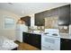 Kitchen showcasing dark cabinets, granite countertops, and modern appliances at 2305 Barnor Dr, Indianapolis, IN 46219