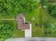 Aerial view of a charming home surrounded by lush greenery, a fire pit, and a well-manicured lawn at 2750 Chamberlin Dr, Indianapolis, IN 46227