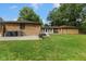 The home features an expansive backyard with a well-maintained lawn, patio area, and mature trees at 2750 Chamberlin Dr, Indianapolis, IN 46227