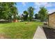 Spacious backyard with a fire pit, storage shed, trampoline and lush greenery, perfect for outdoor activities at 2750 Chamberlin Dr, Indianapolis, IN 46227