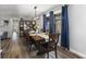 Dining room with a large table, wood floors, modern lighting, and blue curtains at 2750 Chamberlin Dr, Indianapolis, IN 46227