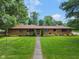 Charming brick ranch with manicured lawn and mature trees in a quiet residential neighborhood at 2750 Chamberlin Dr, Indianapolis, IN 46227