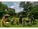 Humorous backyard scene with realistic animal figures hosting a playful barbecue under a sunny sky at 2922 E 62Nd St, Indianapolis, IN 46220