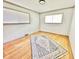 Empty room with hardwood flooring, a large rug, and natural light at 2922 E 62Nd St, Indianapolis, IN 46220