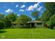 Charming single-story home with a well-manicured lawn and mature trees at 2922 E 62Nd St, Indianapolis, IN 46220