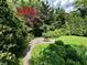 Secluded garden area with a quaint table setting amidst lush greenery and serene landscaping at 2922 E 62Nd St, Indianapolis, IN 46220
