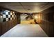 Room features wood paneled walls with unique mural, creating a stylish and inviting interior space at 2922 E 62Nd St, Indianapolis, IN 46220