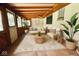 Cozy sunroom featuring wicker furniture, plants, and a patterned area rug at 2922 E 62Nd St, Indianapolis, IN 46220