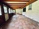 Spacious sunroom with brick flooring, exposed beams, and a vintage feel at 2922 E 62Nd St, Indianapolis, IN 46220