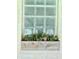 A glass block window with a wooden planter box filled with succulents and greenery at 2922 E 62Nd St, Indianapolis, IN 46220