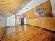 Attic space with wood-paneled walls and hardwood floors provides an area for renovation at 3042 Newton Ave, Indianapolis, IN 46201