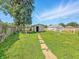 Grassy backyard with dilapidated sheds at 3042 Newton Ave, Indianapolis, IN 46201