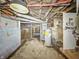 Unfinished basement with cement walls, water heater, and overhead light fixture at 3042 Newton Ave, Indianapolis, IN 46201