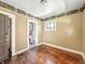 A bedroom featuring wood floors, a window, and a doorway, awaiting renovation at 3042 Newton Ave, Indianapolis, IN 46201