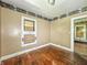 Bedroom features wood floors and a boarded-up window; ready for renovation at 3042 Newton Ave, Indianapolis, IN 46201