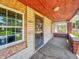 Covered front porch featuring brick columns and concrete flooring at 3042 Newton Ave, Indianapolis, IN 46201