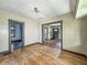 Open-concept living room with hardwood floors needing some love and multiple doorways at 3042 Newton Ave, Indianapolis, IN 46201