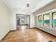 Spacious living room with large windows, hardwood floors needing some love and multiple doorways at 3042 Newton Ave, Indianapolis, IN 46201