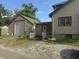 View of the back of the home, showing garage with driveway and back entrance with small deck at 3143 Carson Ave, Indianapolis, IN 46227