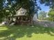 Charming two-story home featuring a brick facade and a cozy front porch nestled in a lush, green lawn at 3143 Carson Ave, Indianapolis, IN 46227