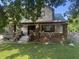 Charming two-story home with brick pillar porch and lush green lawn offers curb appeal and a welcoming entrance at 3143 Carson Ave, Indianapolis, IN 46227