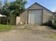 View of the garage with white door, concrete driveway, and a wooden fence to the side at 3143 Carson Ave, Indianapolis, IN 46227