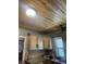 Corner kitchen featuring wood paneled ceiling, oak cabinets, laminate countertops and new faucet at 3143 Carson Ave, Indianapolis, IN 46227