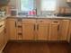 Kitchen sink featuring oak cabinets, laminate countertops and new faucet under a window at 3143 Carson Ave, Indianapolis, IN 46227