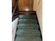 Carpeted staircase in need of repair with wood railing and peeling drywall on the wall at 3143 Carson Ave, Indianapolis, IN 46227