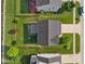 A serene bird's-eye view of a home with a manicured lawn, adjacent to a tranquil stream and green space at 3230 Hemlock St, Whiteland, IN 46184