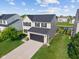 An aerial view of a home featuring a well-kept yard and a long driveway at 3230 Hemlock St, Whiteland, IN 46184