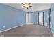 Serene bedroom featuring blue walls, plush carpeting, ceiling fan and a bright window at 3230 Hemlock St, Whiteland, IN 46184
