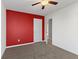 Bedroom featuring neutral walls, red accent wall, and carpet flooring at 3230 Hemlock St, Whiteland, IN 46184