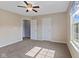 Bright bedroom features neutral walls, plush carpeting, and a ceiling fan for added comfort at 3230 Hemlock St, Whiteland, IN 46184