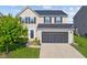 Charming two-story home with a two-car garage and manicured front lawn at 3230 Hemlock St, Whiteland, IN 46184
