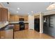 Functional kitchen featuring wooden cabinetry, black appliances, and ample counter space at 3230 Hemlock St, Whiteland, IN 46184