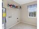 Functional laundry room includes shelving, a window with a view, and vinyl flooring at 3230 Hemlock St, Whiteland, IN 46184