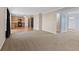 Spacious living room with plush carpeting leading into an open-concept kitchen at 3230 Hemlock St, Whiteland, IN 46184