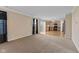 Inviting living area with neutral tones and carpet, flowing into the kitchen space at 3230 Hemlock St, Whiteland, IN 46184