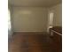 Inviting living room showcasing hardwood floors and a charming piano at 3429 Kinnear Ave, Indianapolis, IN 46218