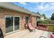 View of the wood deck featuring patio furniture and sliding glass doors to the brick home at 35 Decourcy Ln, Franklin, IN 46131