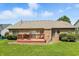 Brick home featuring back deck, well maintained lawn, and mature trees at 35 Decourcy Ln, Franklin, IN 46131