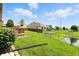 A green backyard extends down to a pond behind the home at 35 Decourcy Ln, Franklin, IN 46131