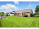 Spacious backyard with green grass, fencing, landscaping, and a brick home at 35 Decourcy Ln, Franklin, IN 46131