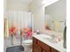 Bathroom featuring a vanity, mirror, commode and a shower tub combo with a colorful curtain at 35 Decourcy Ln, Franklin, IN 46131